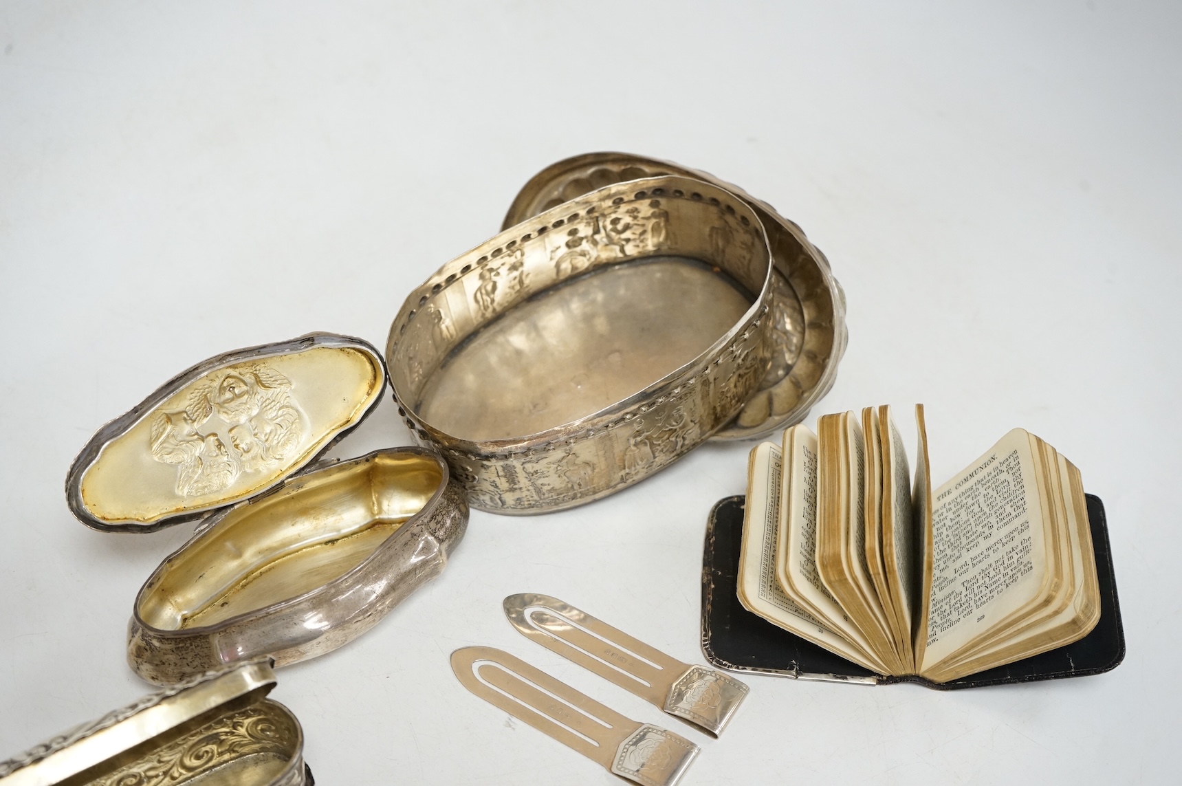 Three late 19th/early 20th century repousse silver trinket boxes, including one with Reynold's Angels decoration, Birmingham, 1899, 91mm, a larger 19th century Dutch white metal oval box and cover, a pair of wishbone sil